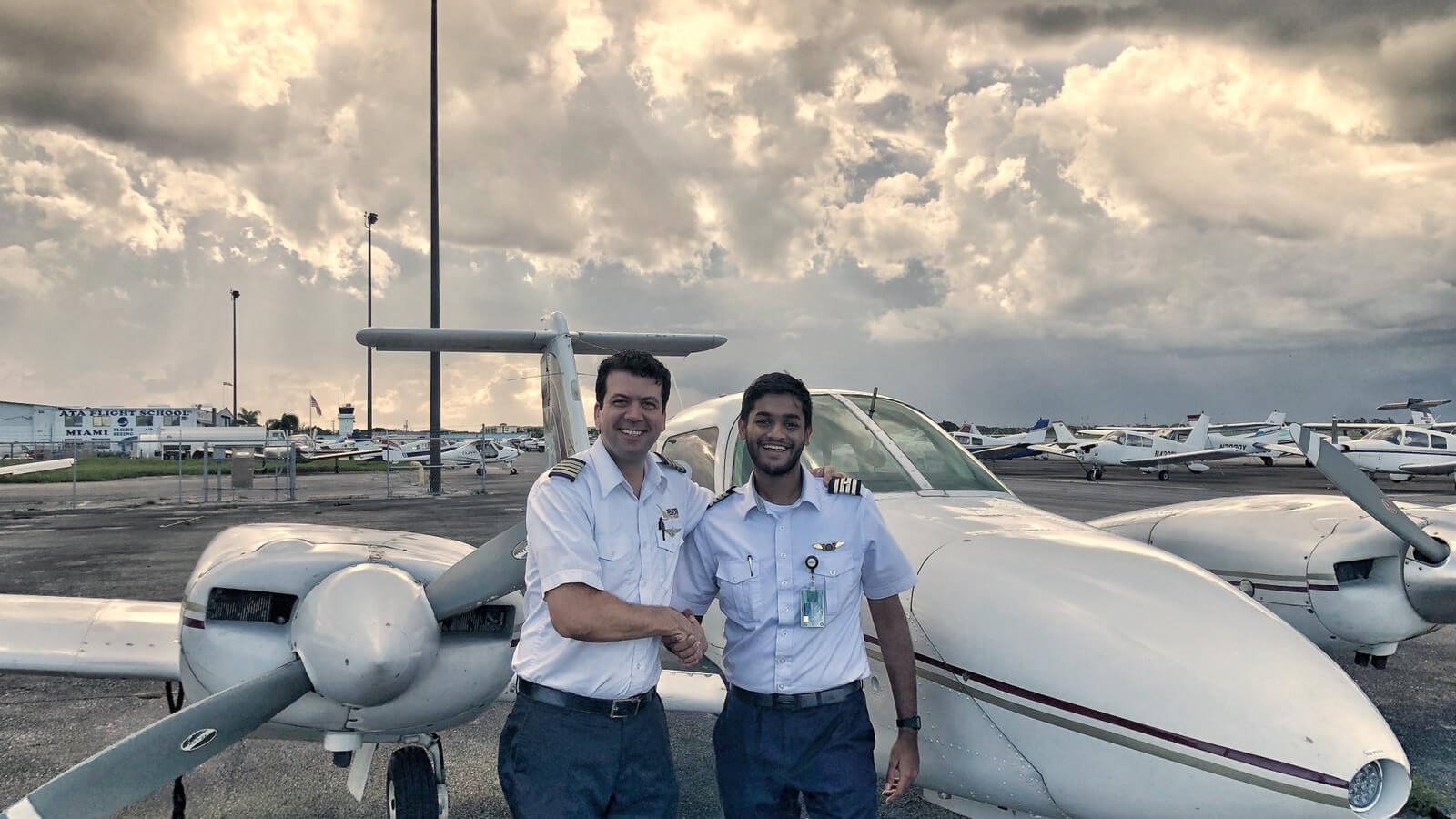 Pelican Flight School students standing in front of an airplane - Photo 2