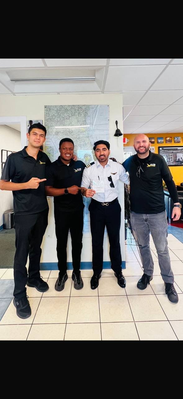 Pelican student with instructors after checkride